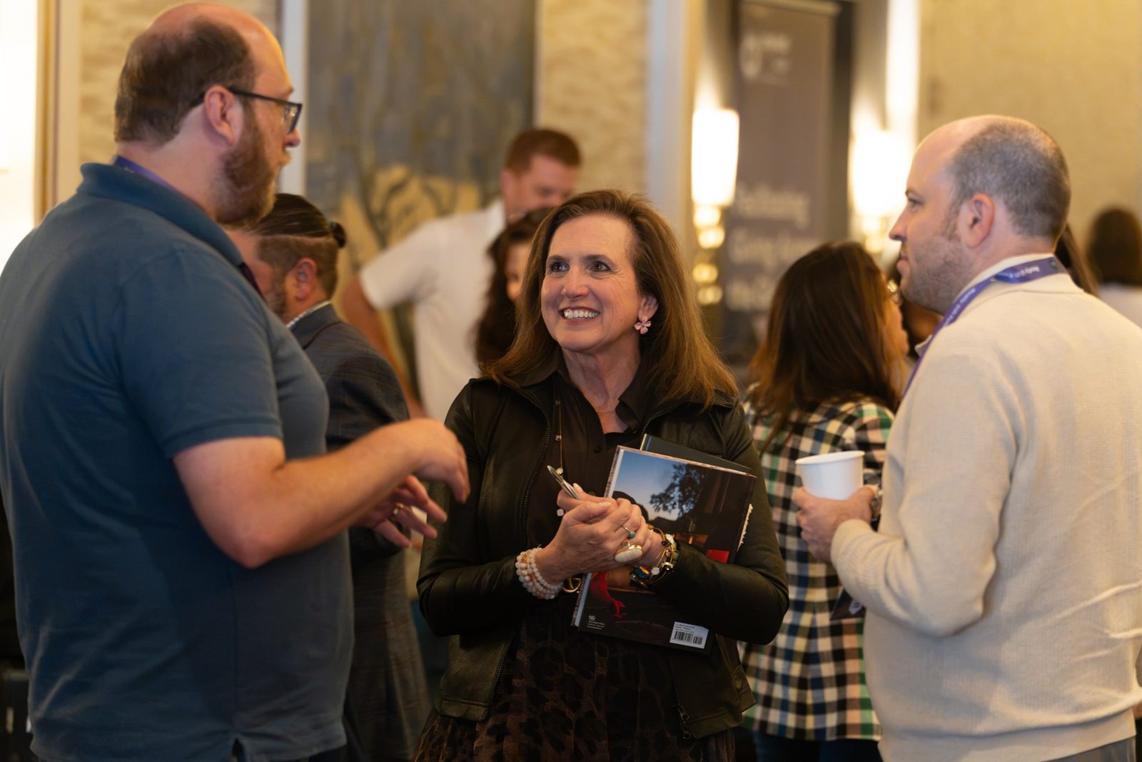 The summit director talking with attendees between sessions