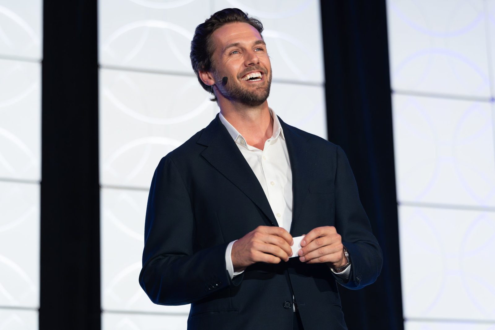 A speaker laughing on the summit stage