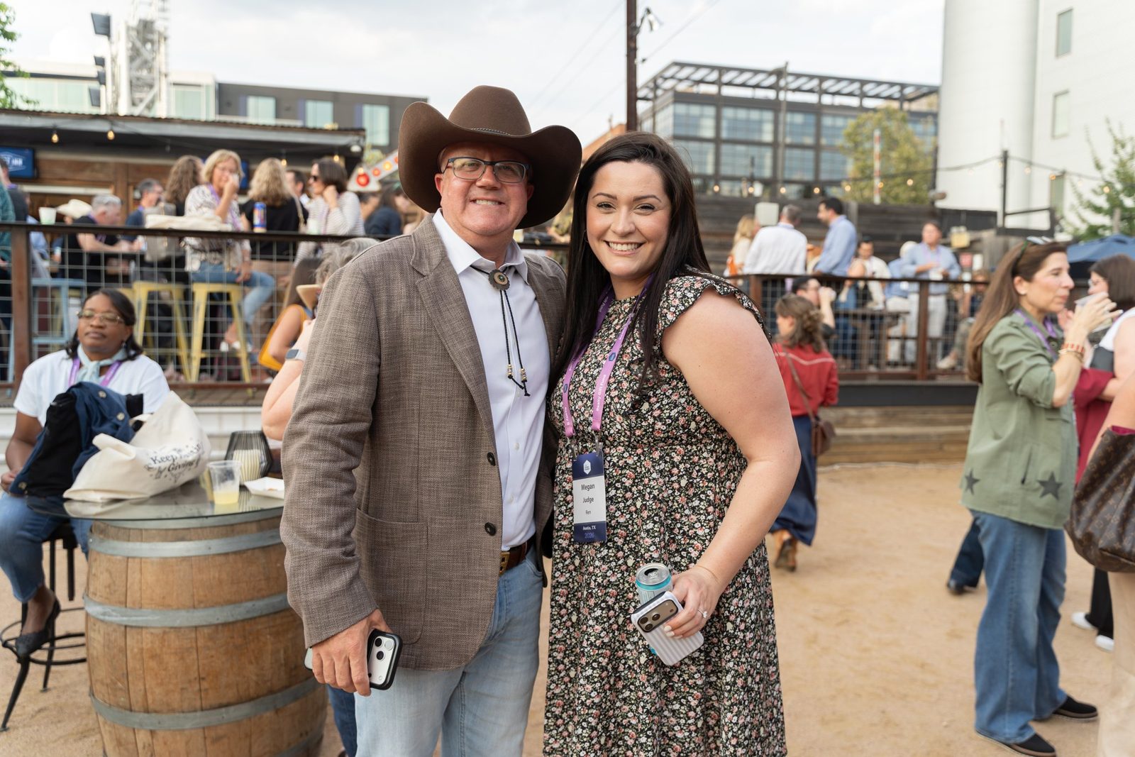 Two attendees in western wear posing together at Scoot Inn